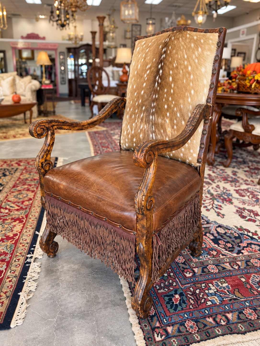A one of a kind leather, fringe, and hide statement chair in the Cadie's Corner showroom